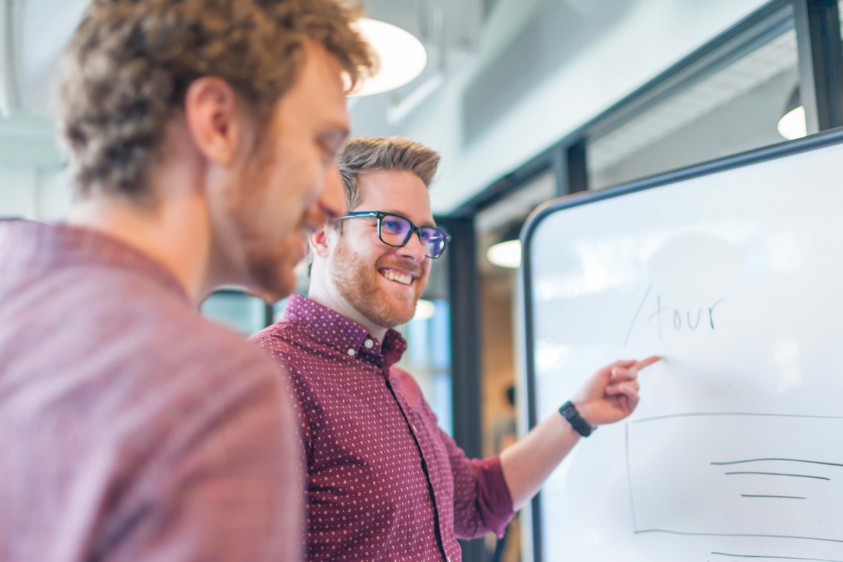 Albert working with a client at a whiteboard